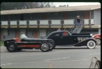 Duesenberg race car owned by Dr. J. P. Young on the left, Model J car 2234 (J-212) on the right;  Golden Tee Resort Lodge, Morro Bay  (Roll 1 Frame 9)